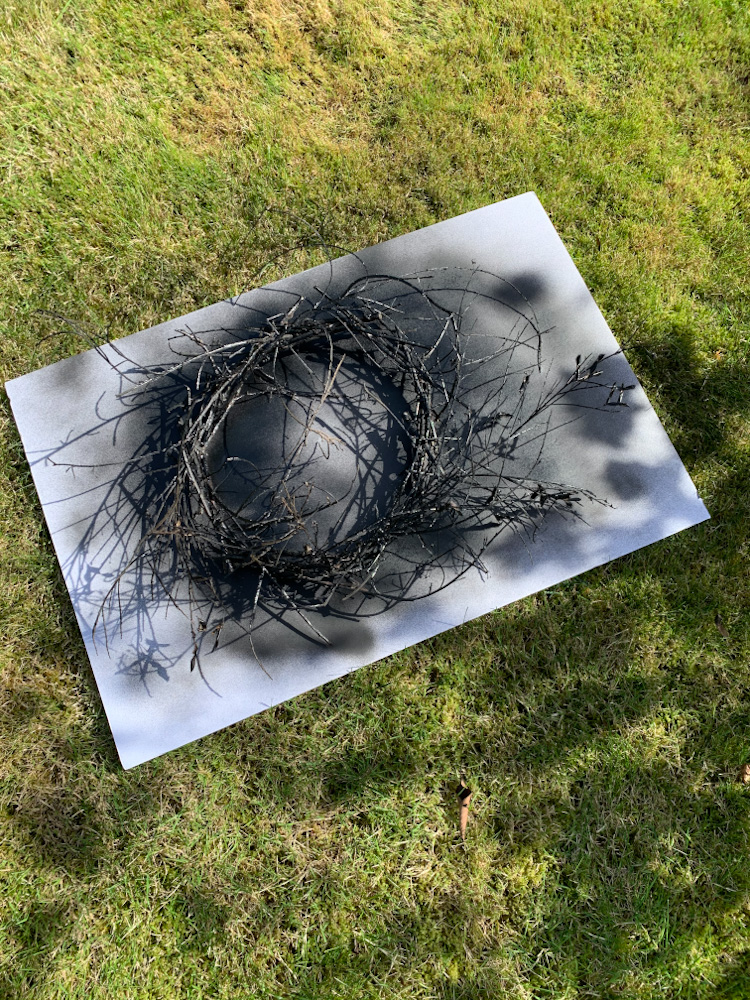 black spray paint on stick wreath