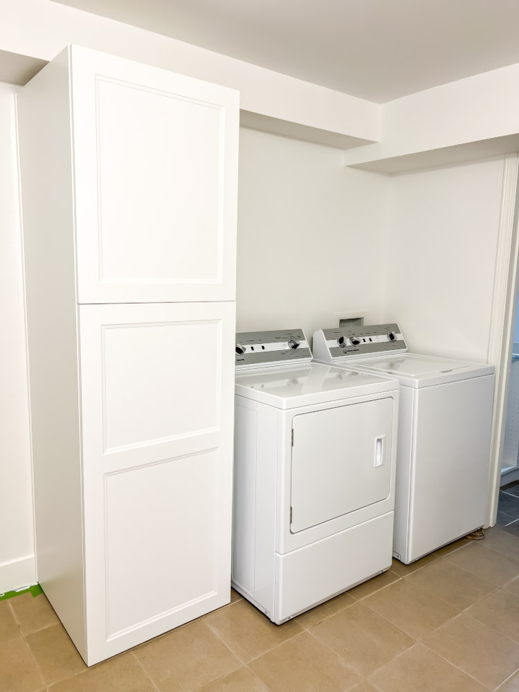 Laundry room with tall cabinet