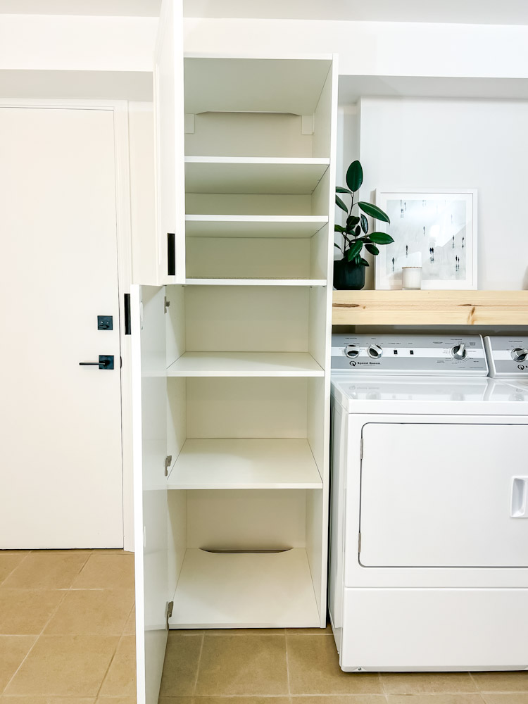 Small laundry room with storage cabinet
